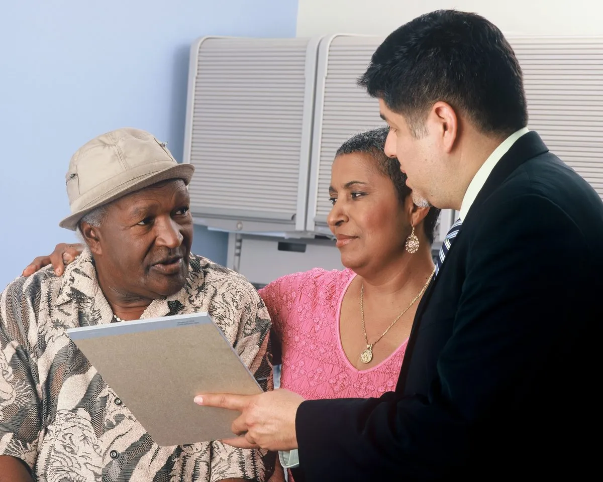 A couple reviewing health plan paperwork with an advisor