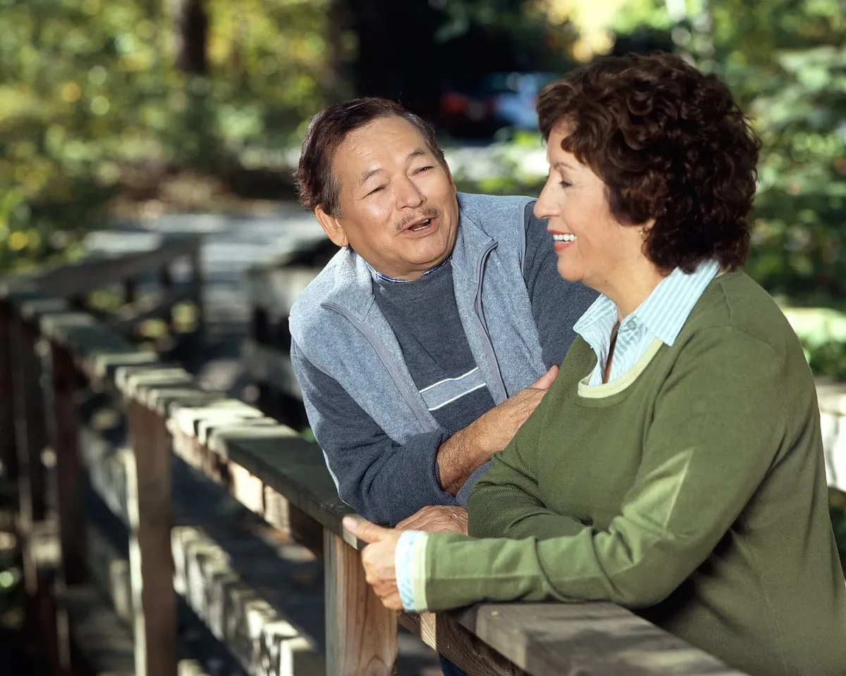 An older couple enjoying a conversation outdoors