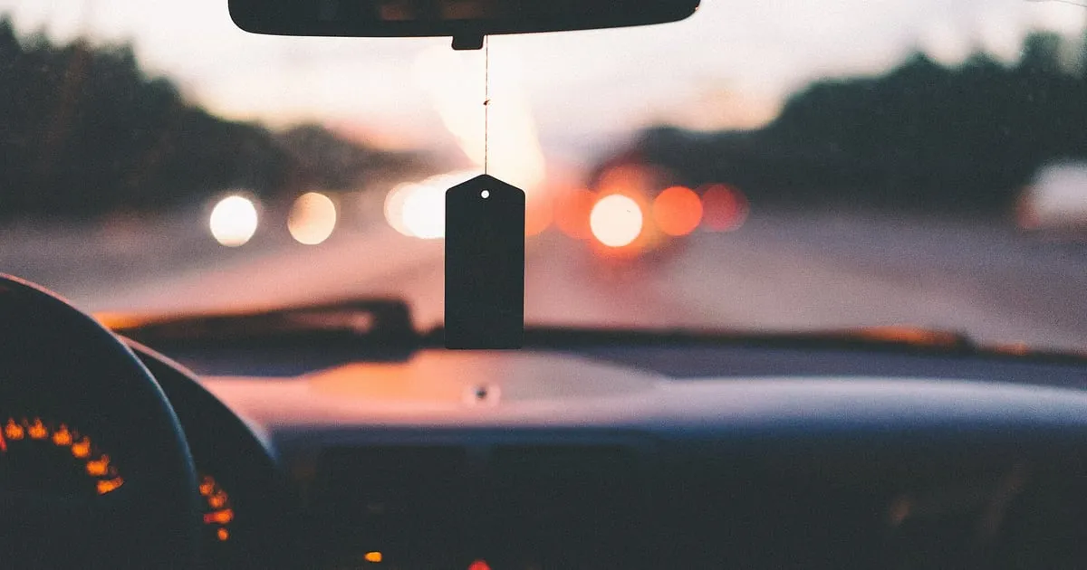 View from the driver's seat of a car on a highway at dusk