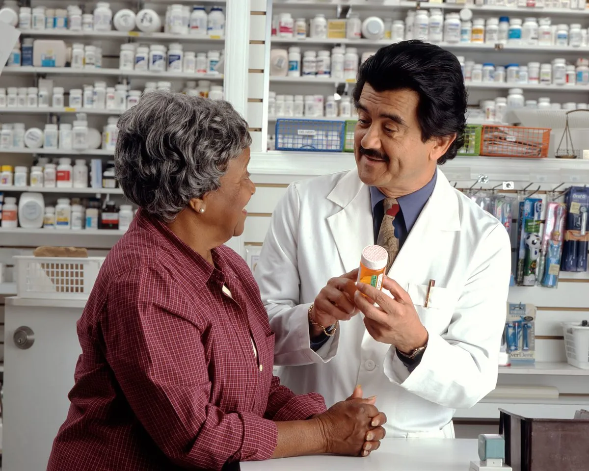 A woman talking with a pharmacist about a prescription at the pharmacy counter